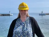 Woman in dress and black shirt in front of lighthouses