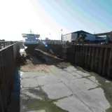 A dry dock with a vessel high and dry